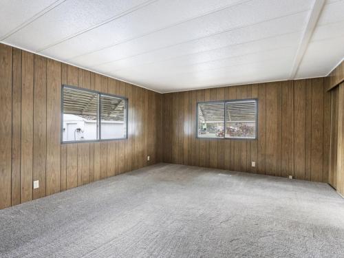 A room with wood paneling walls and a carpeted floor.