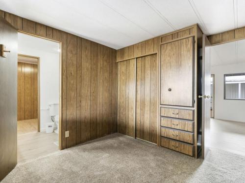 A room with wood paneling walls and a white ceiling.