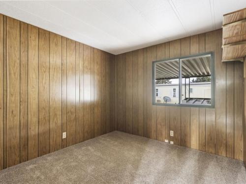 A room with wood paneling walls and carpet.