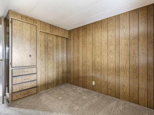 A room with wood paneling and carpet.