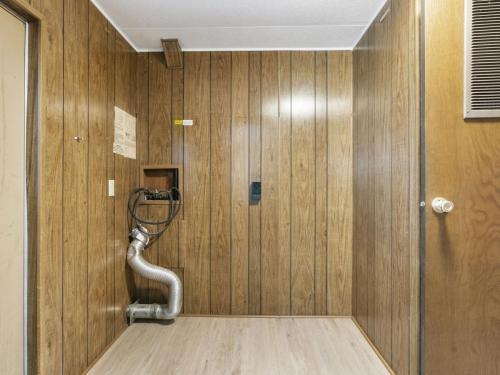 A room with wood paneling and a pipe.