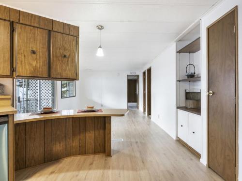 A kitchen with wood cabinets and a wood floor.