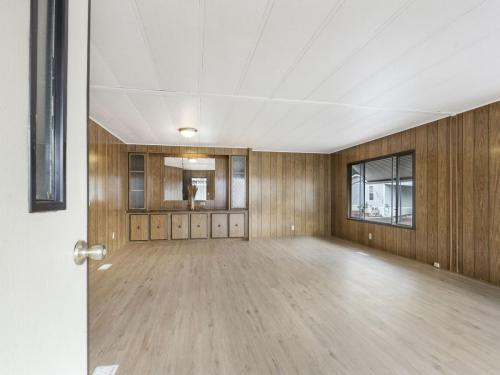 A room with wood paneling and a wood floor.