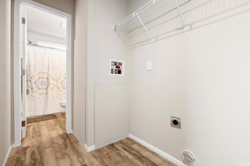 A room with a white wall and wood floor.