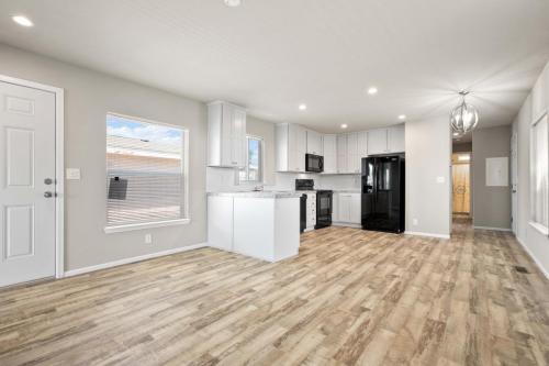 A kitchen and living room with hardwood floor.