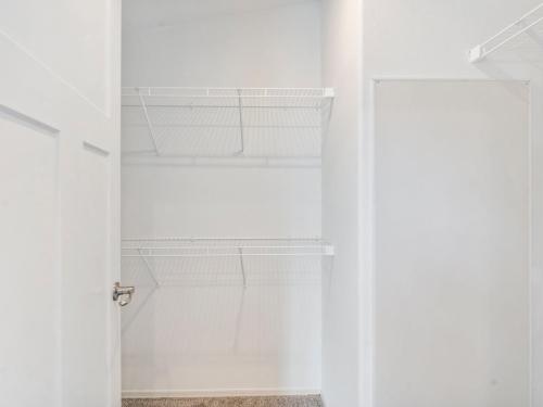 A closet with shelves and a door.