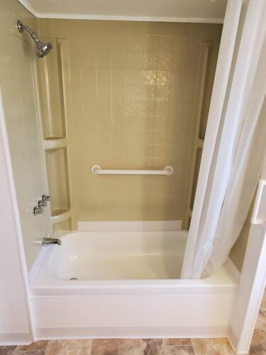 A bathtub with a shower curtain.