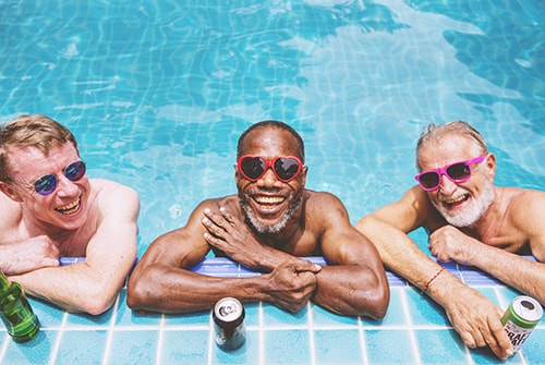 Men in pool smiling